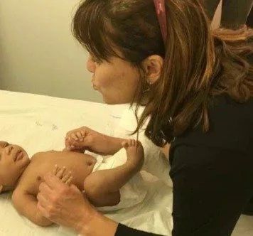 Dr Anna Ey treating a baby